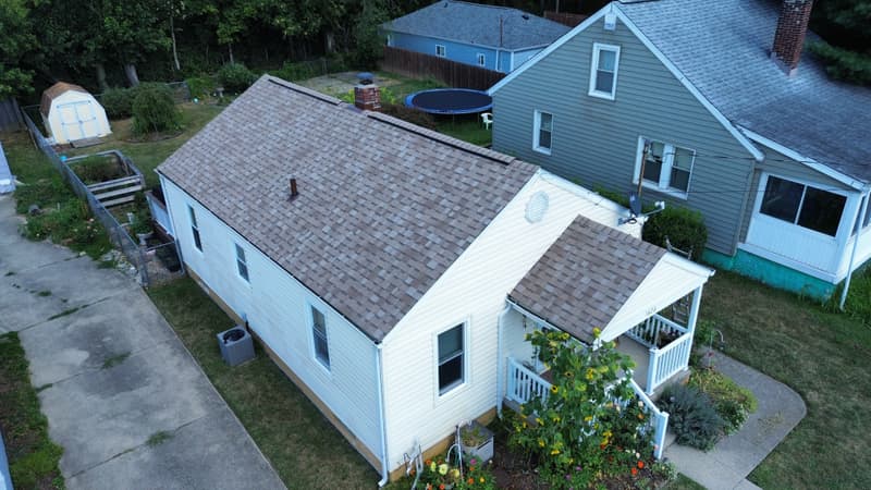 Aerial view of shingle roof on white house